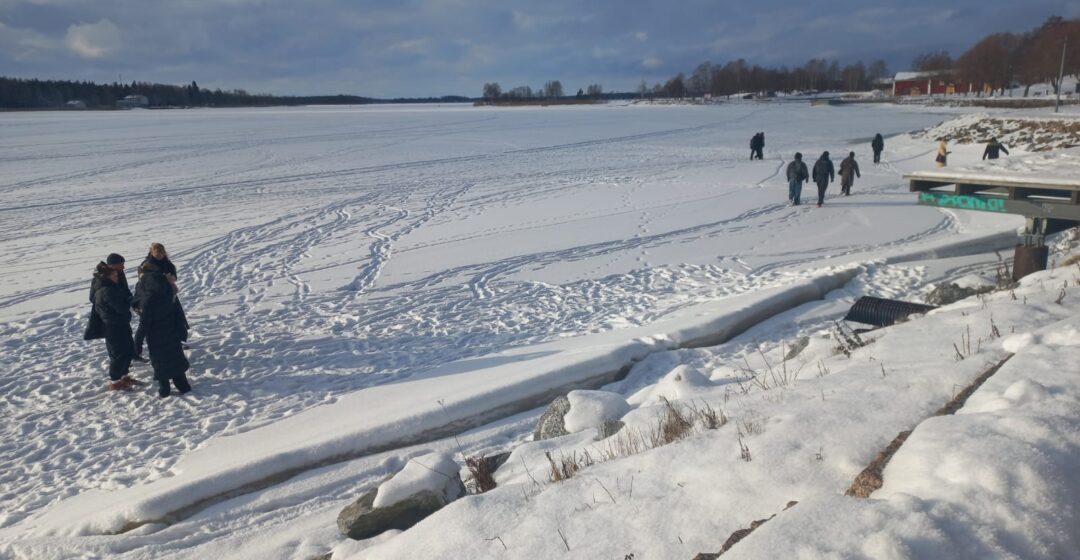 Students walking on the frozen sea, testing lidar