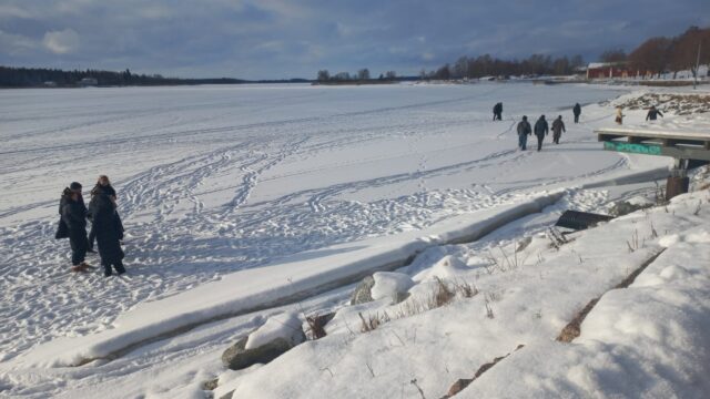 Students walking on the frozen sea, testing lidar