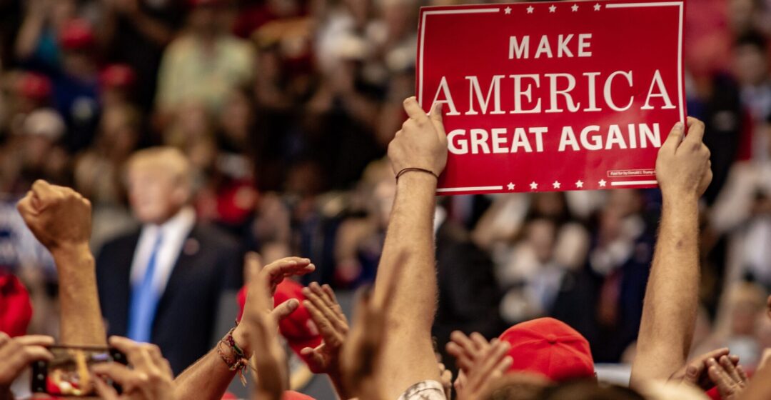 WILKES-BARRE, PA - AUGUST 2, 2018: A fan holds up a "Make America Great Again" sign while President Donald J. Trump delivers a speech during the "Make America Great Again" rally at Mohegan Sun Arena.