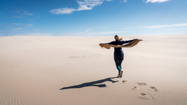 PhD Carita Eklund walking on the sand dune in Denmark